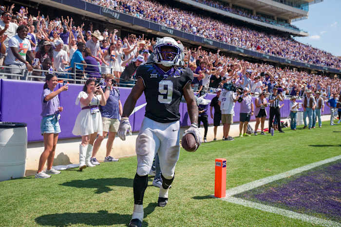 TCU Horned Frogs running back Emani Bailey (9) celebrates after he runs for a touchdown against the SMU Mustangs during the second half at Amon G. Carter Stadium.